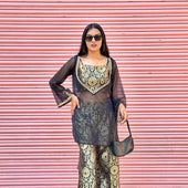 Woman in a stylish outfit with a pink shutter background